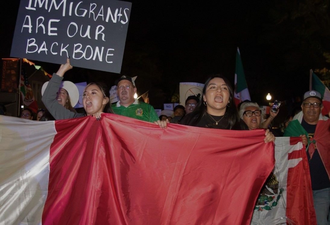 Residents of West Chicago march with flags and signs during a Sept. 16 protest against ICE raids, coinciding with Mexican Independence Day celebrations.