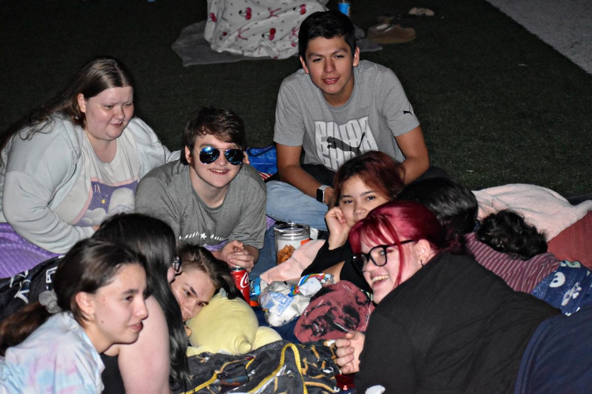 Students enjoy spending time with friends at their first Homecoming Movie Night.