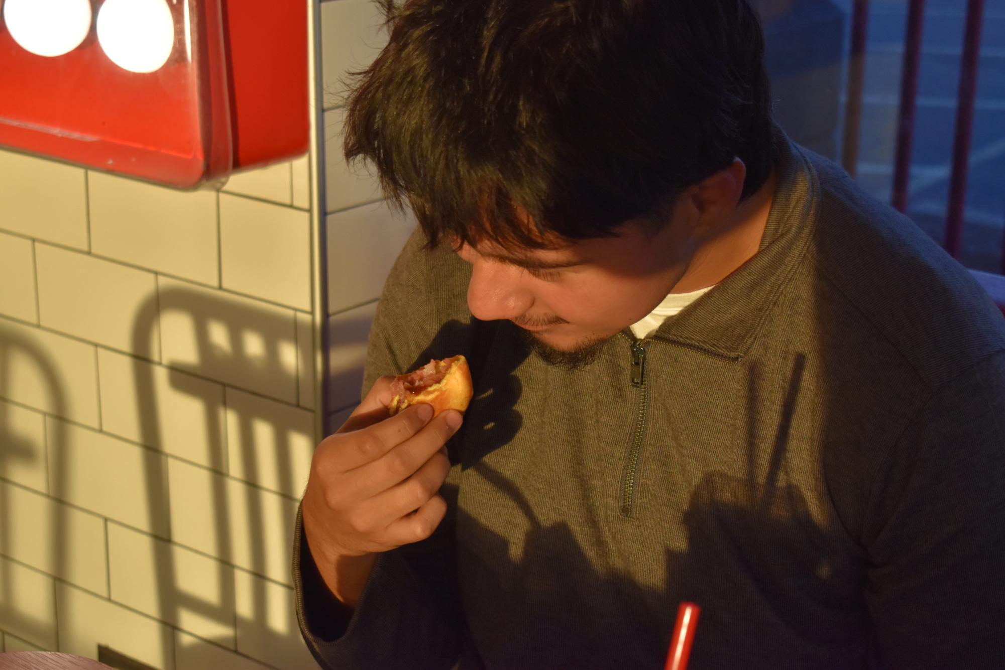 Senior Andres Carmona takes a whiff of the Arby's Classic Roast Beef Sandwich.