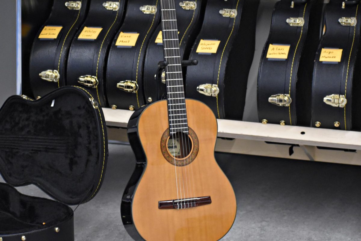A classical guitar rests among instrument cases in the WEGO music wing on Nov. 24, as the new mariachi club begins preparing for its first season.