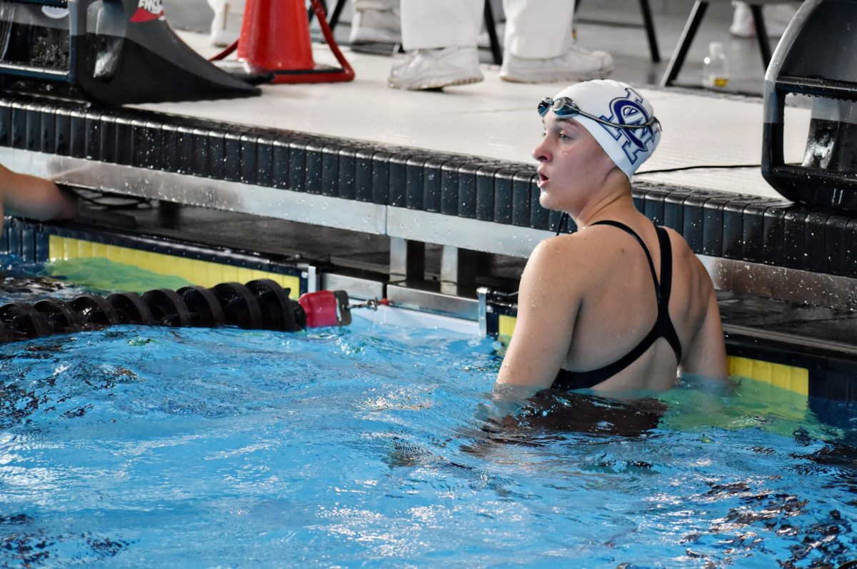 Senior Claire Conklin finishes a race and looks toward the scoreboard during the IHSA State Championships.