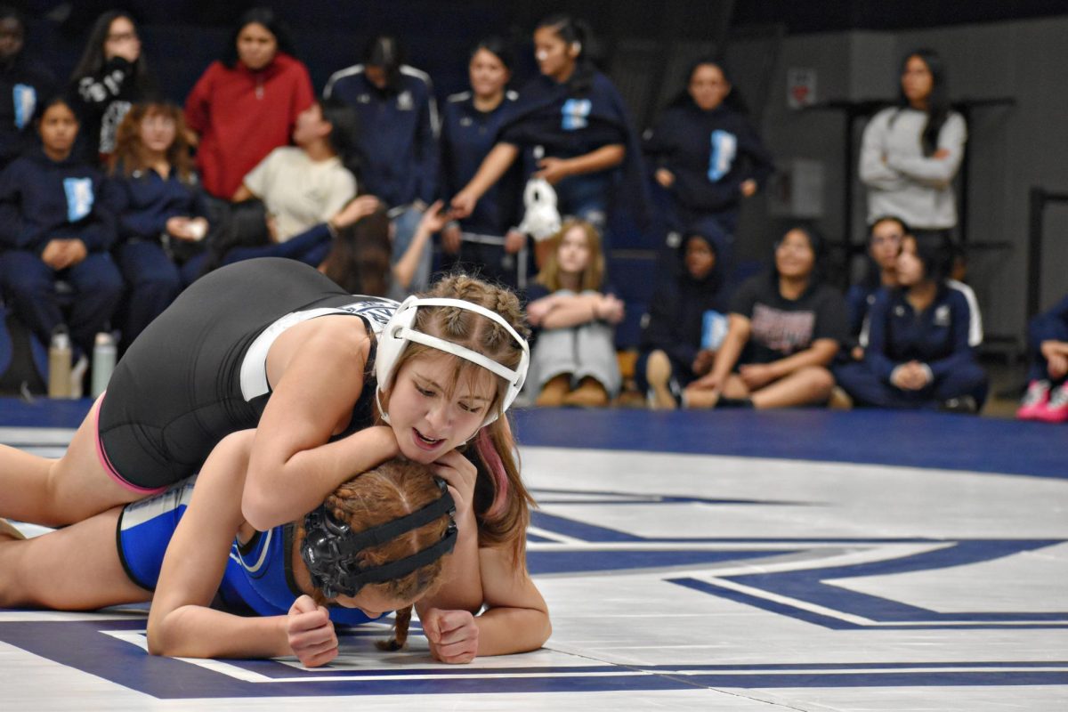 Olivia Zurko, a junior, puts her opponent in a hold on Dec. 3, 2025 in Bishop Gym. The Wildcats took on Riverside Brookfield.