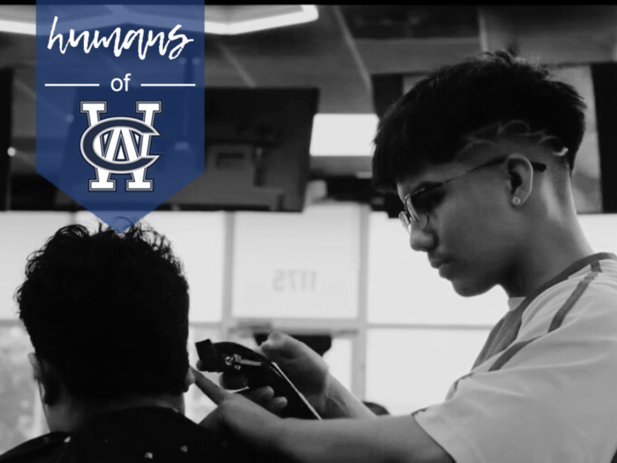 Senior Hugo Martinez giving a client a haircut in a barbershop. (Photo courtesy of Hugo Martinez)