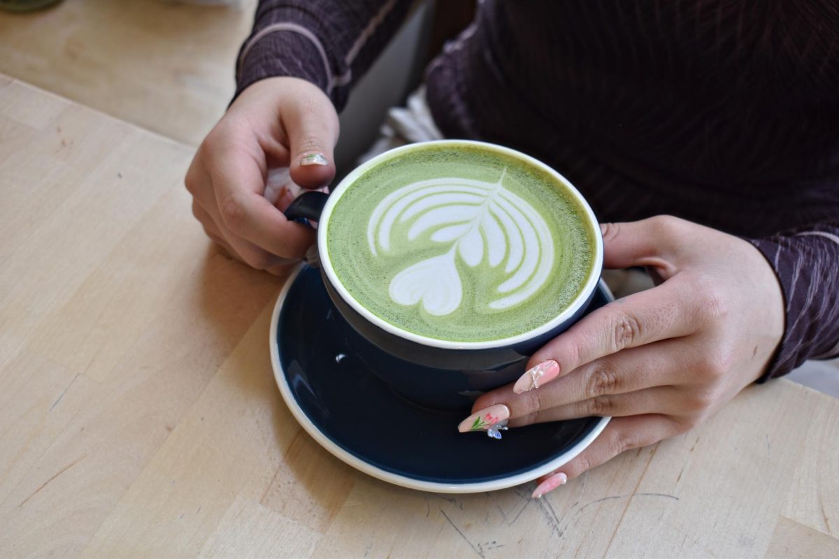 Senior Cris Correa holds a matcha latte at Kindred Coffee Roasters in April 2025, where students discussed the drink’s growing popularity.