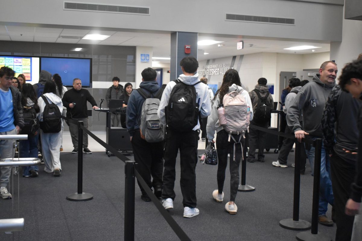 Students entering the building the first week back from winter break, trying out the new 5-Star app.