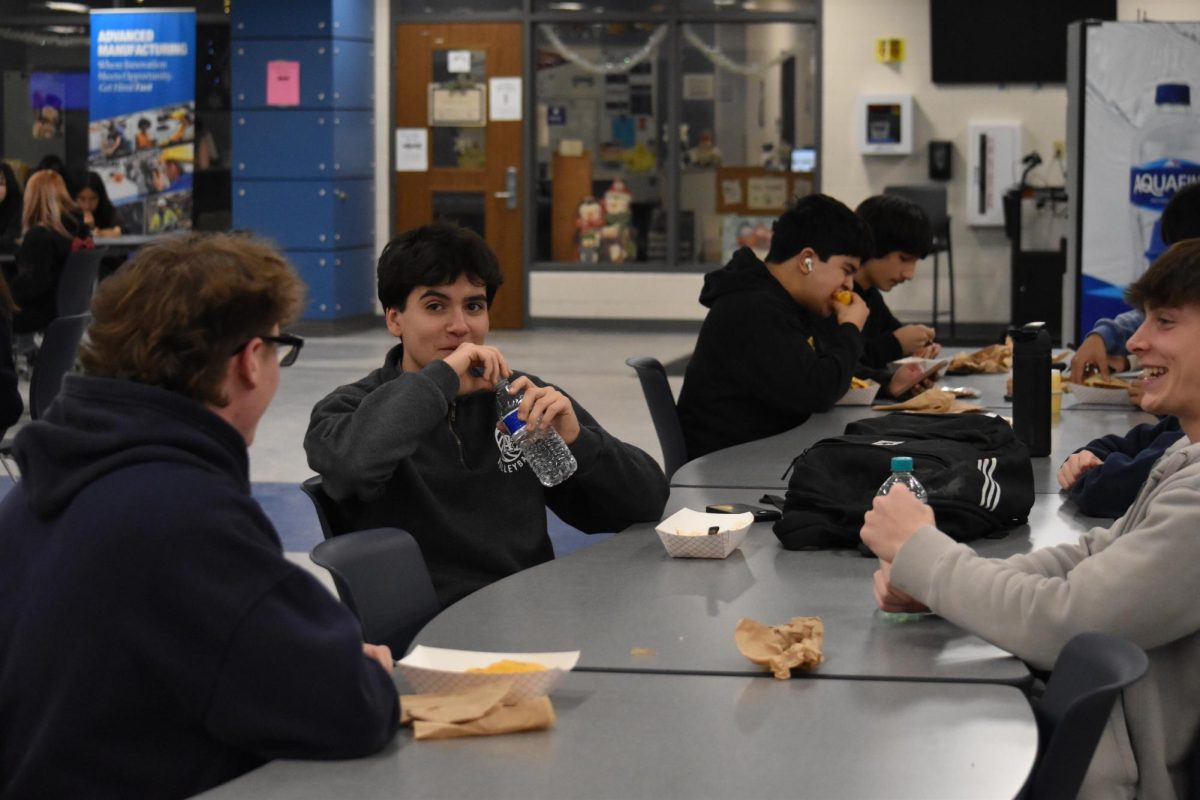Students at West Chicago Community High School, Philip Cabrera, Jack Zeman, and Sean Blickhan sit around their lunch table.