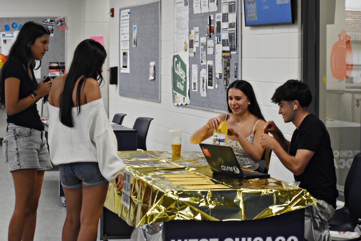 Junior Aaliyah Silva and senior Omar Lutfiyev, both student athletes at WEGO, give up their lunch hour to volunteer for National Honor Society in order to reach the hour requirements for the club. 