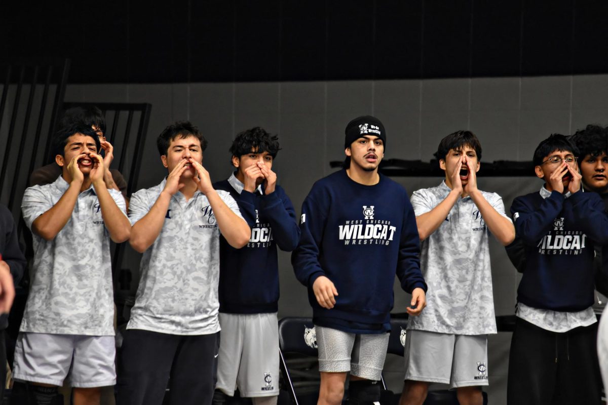 The Wildcats yell "squeeze" during the final match of the night. (Image has been upscaled)