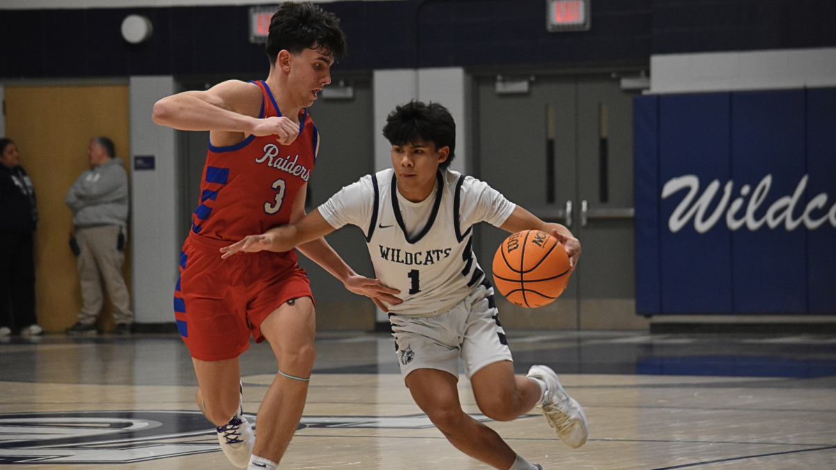 Senior AJ Rotger drives up the court ready to assist his teammate in a layup at basketball game against Glenbard South on Jan. 30. 