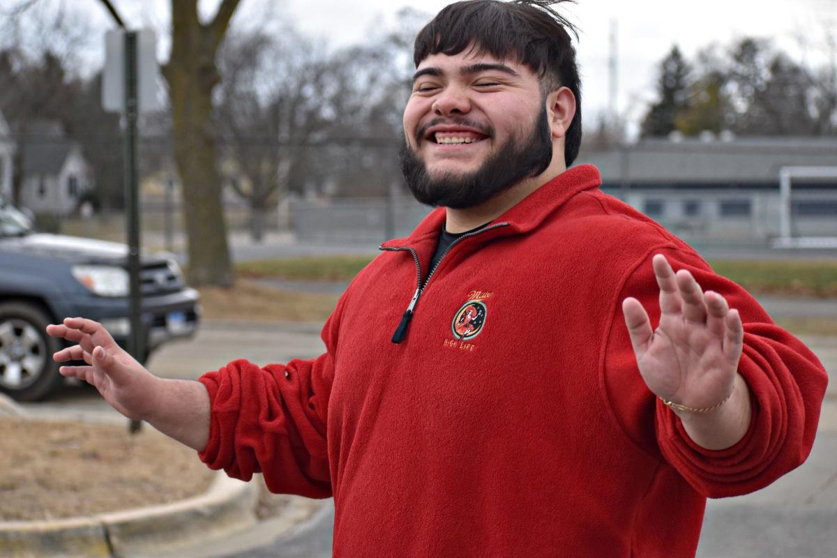 Senior Adrian Alanis reacts to 60-degree weather Feb. 18 in West Chicago. After several days of unusually warm temperatures, rain and snow are expected to return by the weekend.