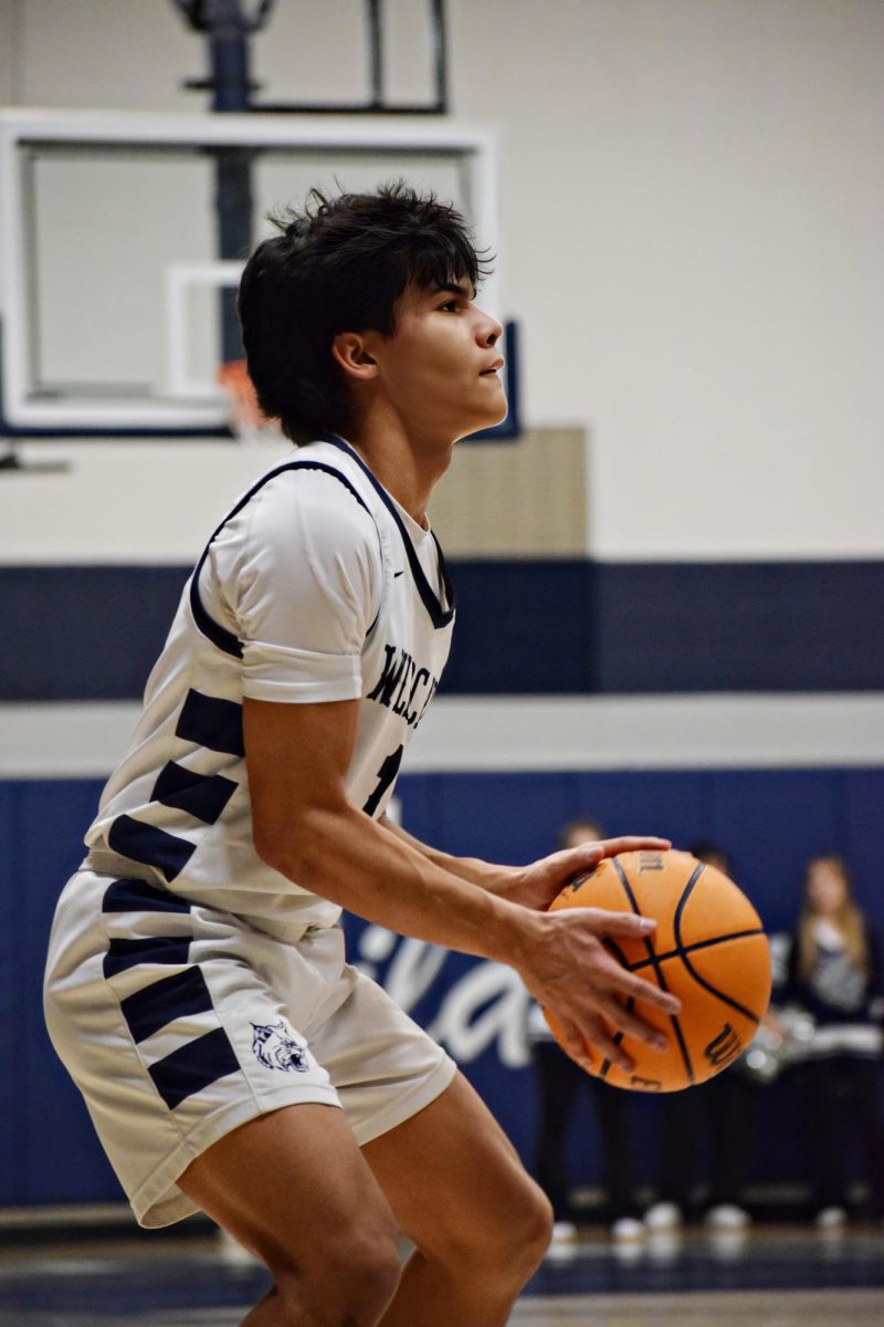 Senior AJ Rotger hits a three pointer early in the first quarter, picking up momentum for his team.