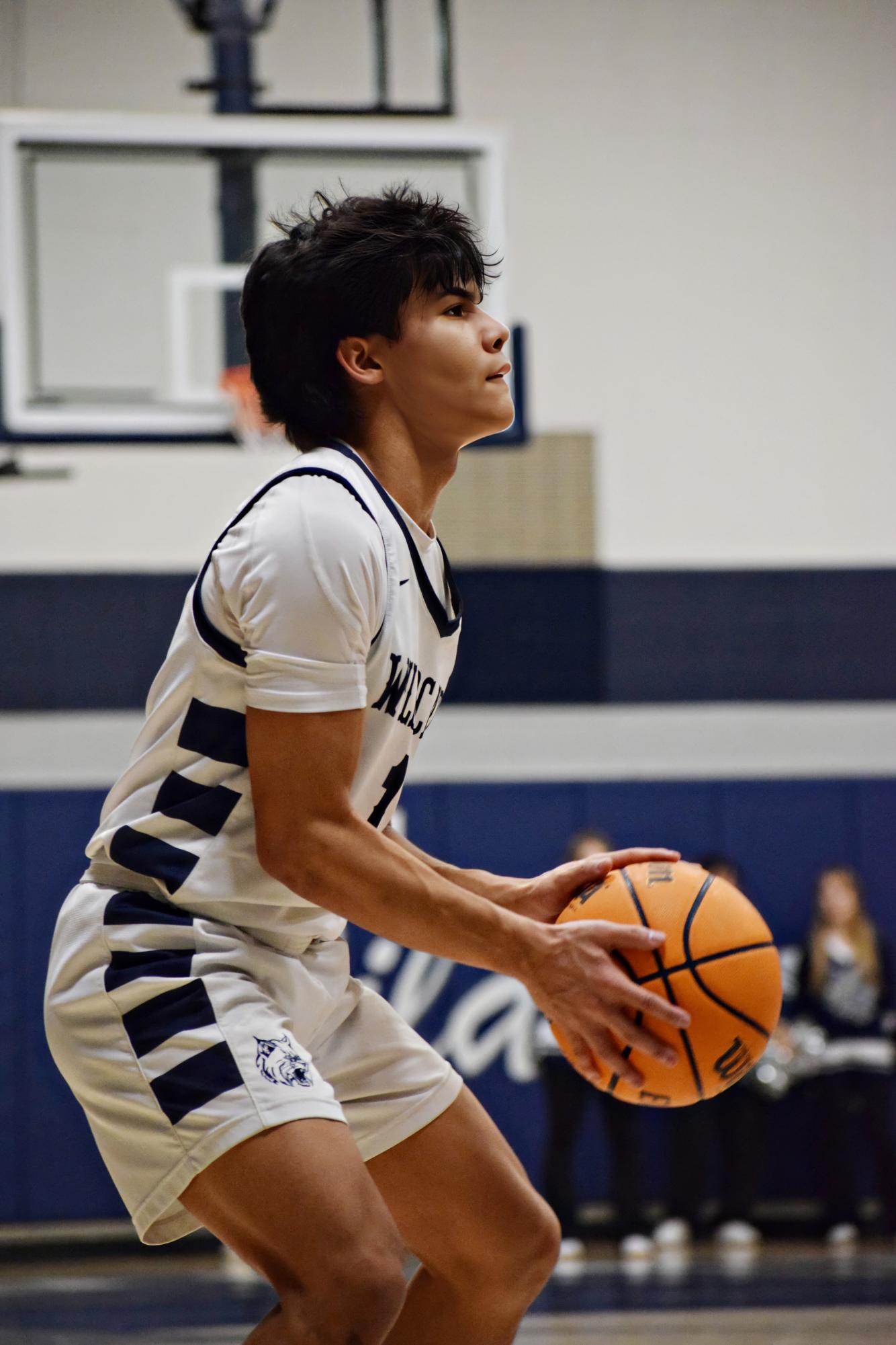 Senior AJ Rotger hits a three pointer early in the first quarter, picking up momentum for his team.