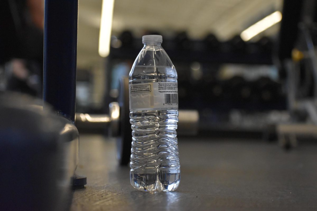 A completely full water is placed on the ground, waiting for someone with thirst to drink from it