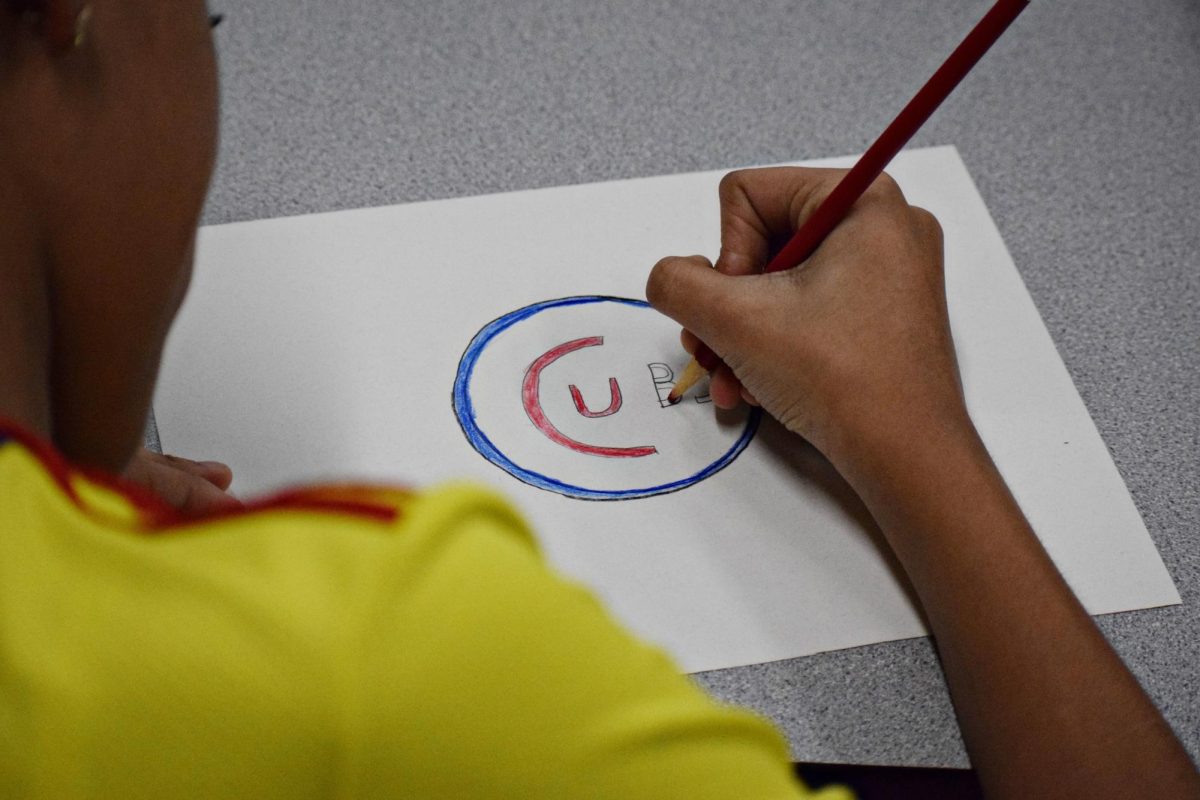 A student finishes coloring the Cubs logo during Study Hall on Feb.13.