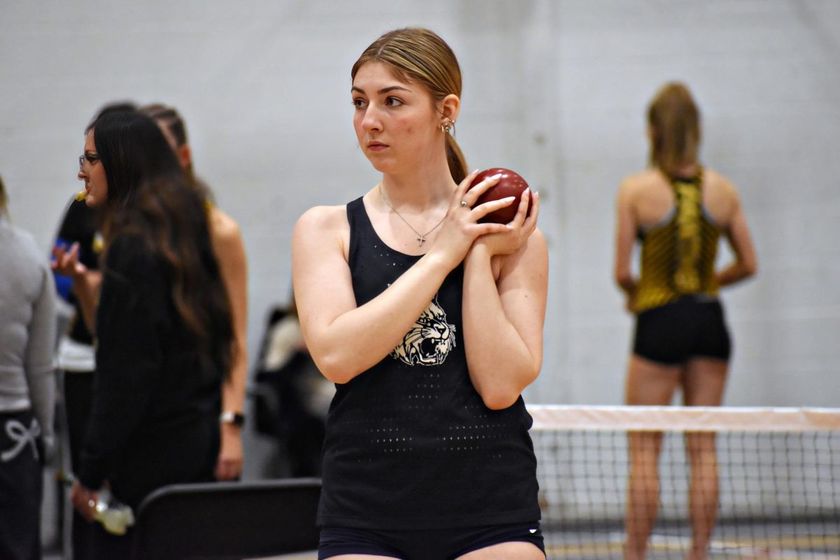 SENIOR SHOT PUTTER: Long-time track and field athlete Julia Bloss, a senior, prepares for her shot put attempt at the meet on Feb. 19 at Glenbard North.
(Image has been upscaled to increase resolution)