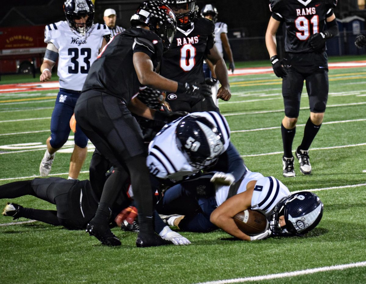 Junior Lincoln Jeffrey and senior Roman Zolota face man-on-man contact in the middle of the field while running an offensive play.