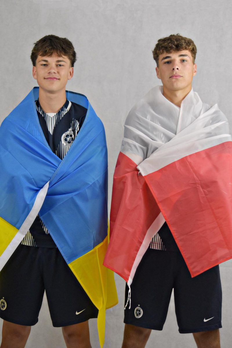 Kuba Slupski (right) and Dimitry Stetsik pose with the flags of Poland and Ukraine during the Wildcat Chronicle fall media day.
