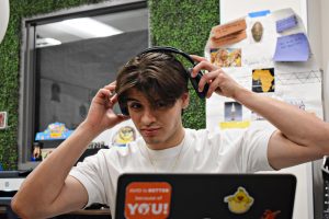 Senior Aleksander Ochoa reacts while listening to the 2026 World Cup anthem “Lighter” at his desk on April 29.