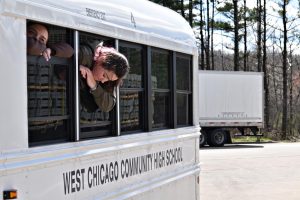 Seniors Aly Dusing and Miley Pegg look out from the minibus window while stopped at a rest area in Lyndon Station, Wis., on April 19 following a mechanical issue that delayed the group’s return from Minneapolis.