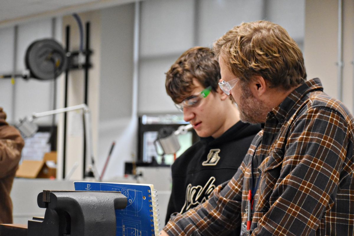 Providing one-on-one support, architectural/drafting teacher Kurt Johnson works with a student during class at West Chicago Community High School. Career-focused courses like drafting help students explore educational pathways tied to future careers.