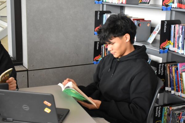 Senior AJ Rotger reads in the Learning Resource Center.