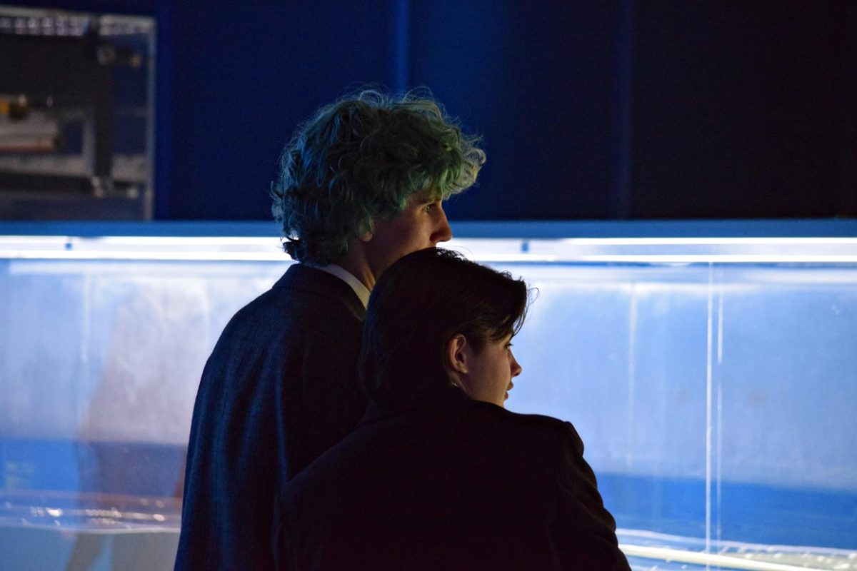 Junior Caiden McDougall and senior Bo Dragosh peer at one of the many exhibits open at prom, which was held at the Museum of Science and Industry in downtown Chicago in May 2026.
