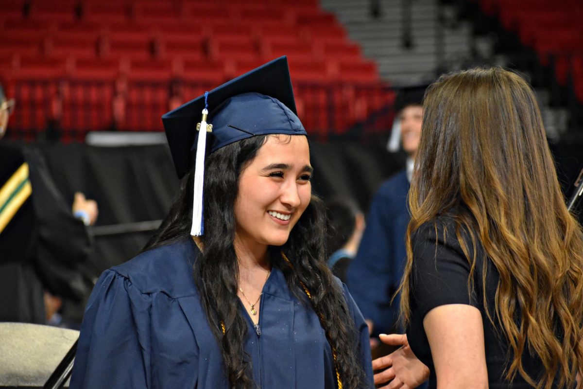 Senior Gloria Granados shakes hands with Dean Janet Hurtado as she collects her diploma on May 19, 2026.