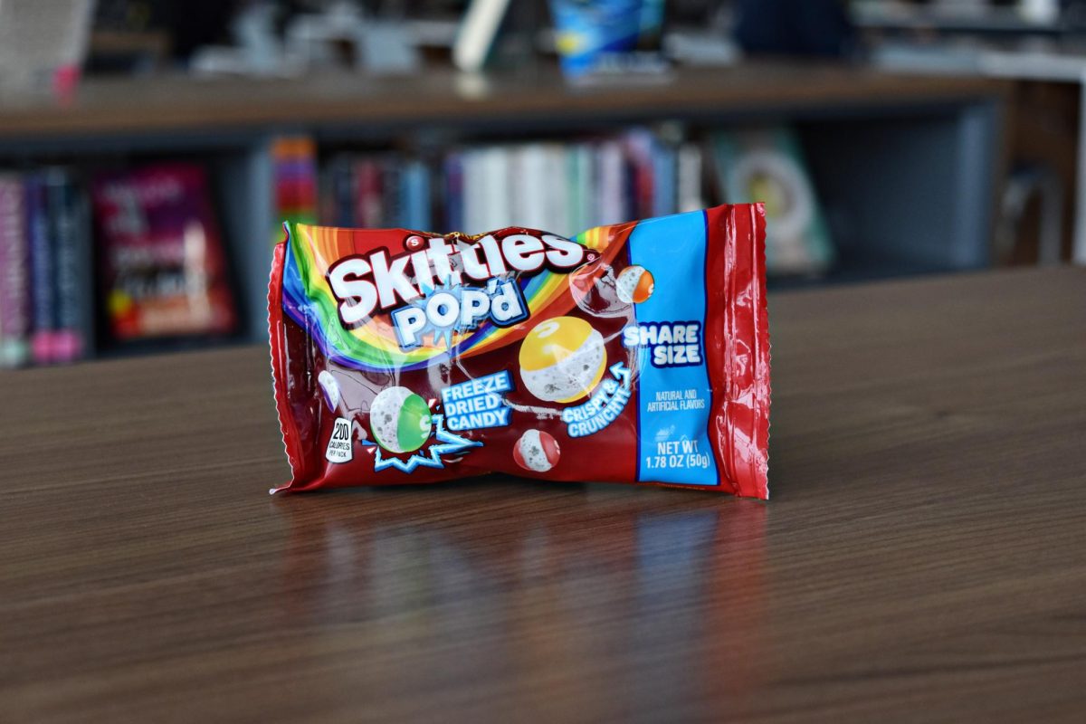 A bag of Skittles Pop’d sits on a bookshelf in WCCHS' library before being tested by students in May 2026. While the candy gained attention for its freeze-dried texture, reviewers found the snack disappointing compared to regular Skittles.